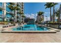 Condo community pool with clear blue water, plenty of lounge chairs and lush landscaping at 777 N Ashley Dr # 1509, Tampa, FL 33602