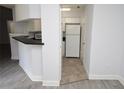 Open kitchen layout with white appliances and tiled flooring at 8659 Fancy Finch Dr # 202, Tampa, FL 33614
