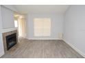 Bright living room featuring a fireplace, light-gray walls, and modern vinyl flooring at 8659 Fancy Finch Dr # 202, Tampa, FL 33614