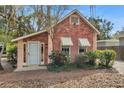 Quaint brick home with an inviting front entrance and manicured landscaping providing a warm welcome at 1105 E 33Rd Ave, Tampa, FL 33603