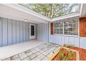 Inviting front porch with light-blue accents, offering a warm welcome and enhanced curb appeal to the home at 12613 Blackberry Row, Hudson, FL 34667