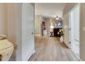 Bright entryway featuring wood-look floors, white trim, and an open view into the living area at 13454 Graham Yarden Dr, Riverview, FL 33579
