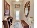 Inviting foyer featuring elegant décor, a decorative mirror, and stylish furnishings at 13454 Graham Yarden Dr, Riverview, FL 33579