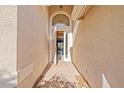 Charming entryway with brick flooring, a brightly lit white door, and a glimpse into the home at 16023 Golden Lakes Dr, Wimauma, FL 33598