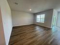 Open living space with wood-look flooring and ample natural light at 17048 James Trl, Parrish, FL 34219