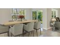 Well-lit dining area with a large window and sliding glass door leading to the backyard at 17056 James Trl, Parrish, FL 34219