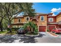 Charming condo with colorful accents, well-manicured landscaping, and attached garages at 2138 Chianti Pl # 142, Palm Harbor, FL 34683
