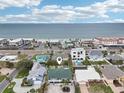 Aerial view of a beautiful home's location, only steps away from beach access on a sunny day at 2710 Hibiscus W Dr, Belleair Beach, FL 33786