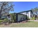 The side of a two story home with landscaping and an enclosed porch at 2904 Lichen Ln # A, Clearwater, FL 33760