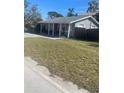 Quaint home with a covered front porch and a well-maintained grassy yard at 300 W 52Nd S St, St Petersburg, FL 33707