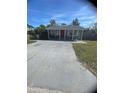 Cozy single-story home featuring a covered front porch and a wide driveway at 300 W 52Nd S St, St Petersburg, FL 33707