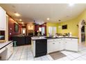 Open kitchen featuring white cabinetry, black appliances, and a view into the adjacent living space at 3701 Barnhouse Pl, Valrico, FL 33596