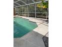 Screened in pool area with stone pavers and tropical foliage creating a private backyard oasis at 3701 Barnhouse Pl, Valrico, FL 33596