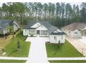 A beautifully landscaped, modern home exterior with a spacious front yard and driveway at 4507 Majestic Hill Loop, Brooksville, FL 34601