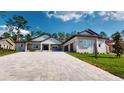 Charming single Gathering home with large driveway, manicured lawn, and inviting facade at 4507 Majestic Hill Loop, Brooksville, FL 34601