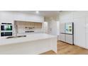 Modern kitchen with large island, white cabinetry, and stainless steel appliances at 4507 Majestic Hill Loop, Brooksville, FL 34601