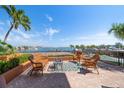 Relax on this beautiful patio with comfortable wicker furniture and enjoy the stunning waterfront views at 5301 Gulf Blvd # C202, St Pete Beach, FL 33706