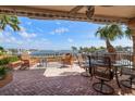 Spacious patio featuring comfortable seating with views of the bay and waterfront at 5301 Gulf Blvd # C202, St Pete Beach, FL 33706