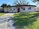 Charming single-story home with a well-manicured lawn and cozy front porch at 6213 N Cameron Ave, Tampa, FL 33614