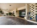 An inviting covered entrance showcases decorative brick, potted plants, and modern glass doors at 700 Island Way # 404, Clearwater Beach, FL 33767