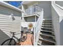 Relaxing patio with outdoor seating, accessed by a staircase, featuring a charming bistro set for enjoying the fresh air at 8350 Savannah Trace Cir # 1808, Tampa, FL 33615