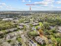 An aerial view showcasing the neighborhood community surrounded by lush trees with Downtown St. Pete in the distance at 9100 Dr Martin Luther King Jr N St # 1508, St Petersburg, FL 33702