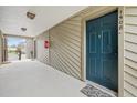 Inviting entrance to the condo featuring a blue front door, neutral siding, and a covered walkway at 9100 Dr Martin Luther King Jr N St # 1508, St Petersburg, FL 33702