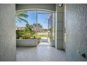 View from the screened entryway showcasing the exterior and neighborhood at 10237 Collar Dr, San Antonio, FL 33576