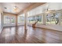 Bright sunroom featuring stylish flooring, ceiling fans, and a relaxing rocking chair at 10237 Collar Dr, San Antonio, FL 33576