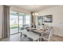 Dining area featuring neutral paint, a wood table, decor, and sliding glass doors for lots of natural light at 10814 Patoka Ter, Parrish, FL 34219