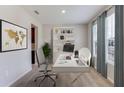Bright office space with a large window, a modern desk, a bookcase, and neutral decor at 12059 Kingsley Trl, Parrish, FL 34219