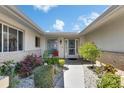 Inviting front entrance with a well-maintained garden and a charming walkway at 1504 Valley Forge Blvd, Sun City Center, FL 33573