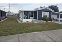 Inviting single-story home featuring a cozy front porch and tidy landscaping at 1710 7Th Sw St # 93, Ruskin, FL 33570