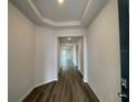 Inviting entryway features wood-look flooring and tray ceiling, creating a welcoming first impression at 17110 James Trl, Parrish, FL 34219