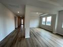 Open living room with wood-look floors, tray ceiling, and an abundance of natural light at 17110 James Trl, Parrish, FL 34219