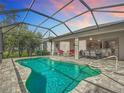 Enjoy the Florida lifestyle in this screened-in pool and lanai at 19724 Fort King Run, Brooksville, FL 34601