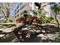 Exterior angle view of condo building showing balcony views and lush tropical landscaping around the building at 2630 Pearce Dr # 107, Clearwater, FL 33764