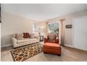 Cozy living room with a large window, a couch, chair with ottoman, and a bright area rug at 2934 Lichen Ln # C, Clearwater, FL 33760