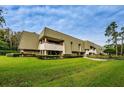 View of multi-Gathering residential building with well-maintained landscaping, walkways and outdoor living space at 36750 Us Highway 19 N # 6-214, Palm Harbor, FL 34684