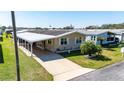This lovely single Gathering features a neutral exterior, carport, driveway, and well-manicured lawn at 36838 Tara Ave, Zephyrhills, FL 33542