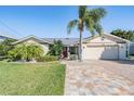 Charming single Gathering home featuring a paver driveway and a well manicured lawn at 4383 Biscayne Dr, Hernando Beach, FL 34607