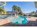 Private pool area with brick patio, ideal for relaxation and entertainment with views of the canal and boat dock at 4383 Biscayne Dr, Hernando Beach, FL 34607