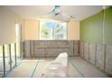 Bathroom undergoing renovation, featuring a window and an existing toilet covered in plastic at 4715 Bay Ne St # 126, St Petersburg, FL 33703