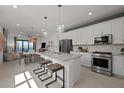 Open floorplan kitchen, stainless steel appliances and an island with seating at 5018 Coastal Oak Ct, Lakewood Ranch, FL 34211