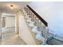 Staircase leading up from the entrance, carpeted with a decorative runner and white railings at 6323 Newtown Cir # 23A1, Tampa, FL 33615