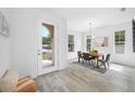 Bright dining room featuring tile floors, modern lighting, and a view of the front yard at 7125 6Th N Ave, St Petersburg, FL 33710