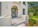 Inviting front porch with stucco detail and a stylish glass-paneled front door at 7125 6Th N Ave, St Petersburg, FL 33710