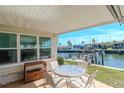 Cozy covered patio with outdoor seating, overlooking a picturesque waterfront canal and neighboring houses at 18675 Us Highway 19 N # 217, Clearwater, FL 33764