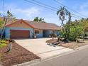 Charming single-story home boasts well-maintained landscaping and a spacious driveway leading to the attached two-car garage at 2300 S Shore Se Dr, St Petersburg, FL 33705