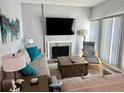 Bright living room featuring a fireplace, sleek furniture, and a modern entertainment setup at 247 Rex Pl # G, Madeira Beach, FL 33708